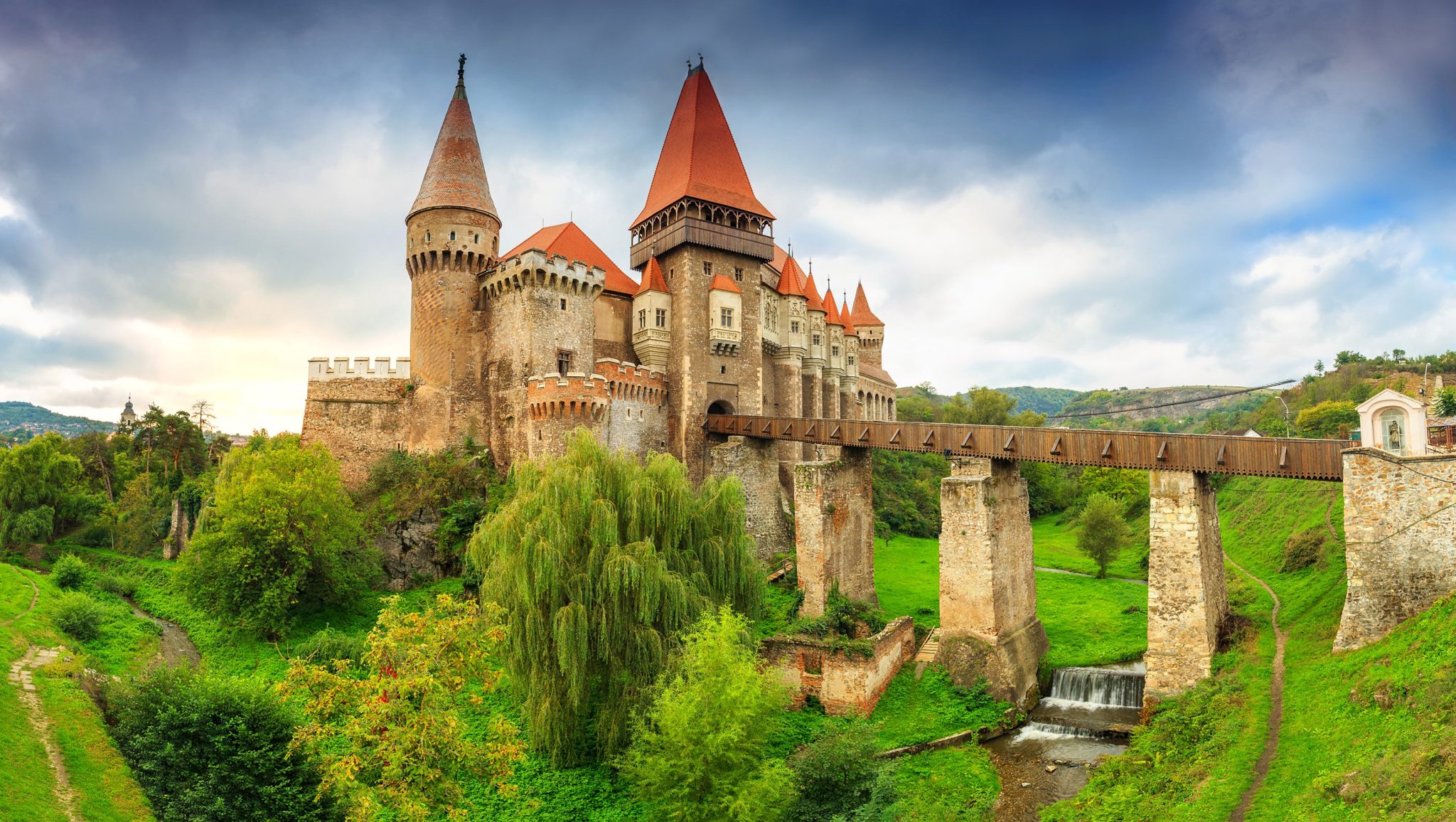 beautiful-panorama-of-the-corvin-castle-with-wooden-bridge-and-small-cascadeshunedoaratransylvania-1